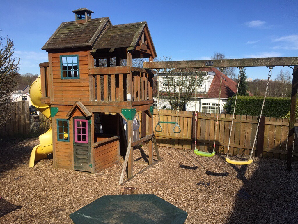 Garden playhouse with swings and slide in Coatbridge, North