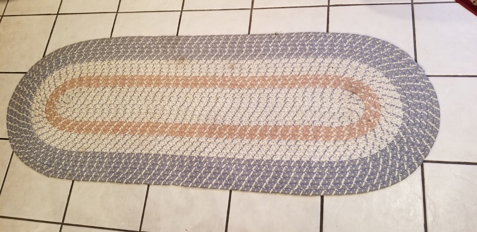 Beautiful, Braided Oval Rug with Blue, White and Mauve colors.