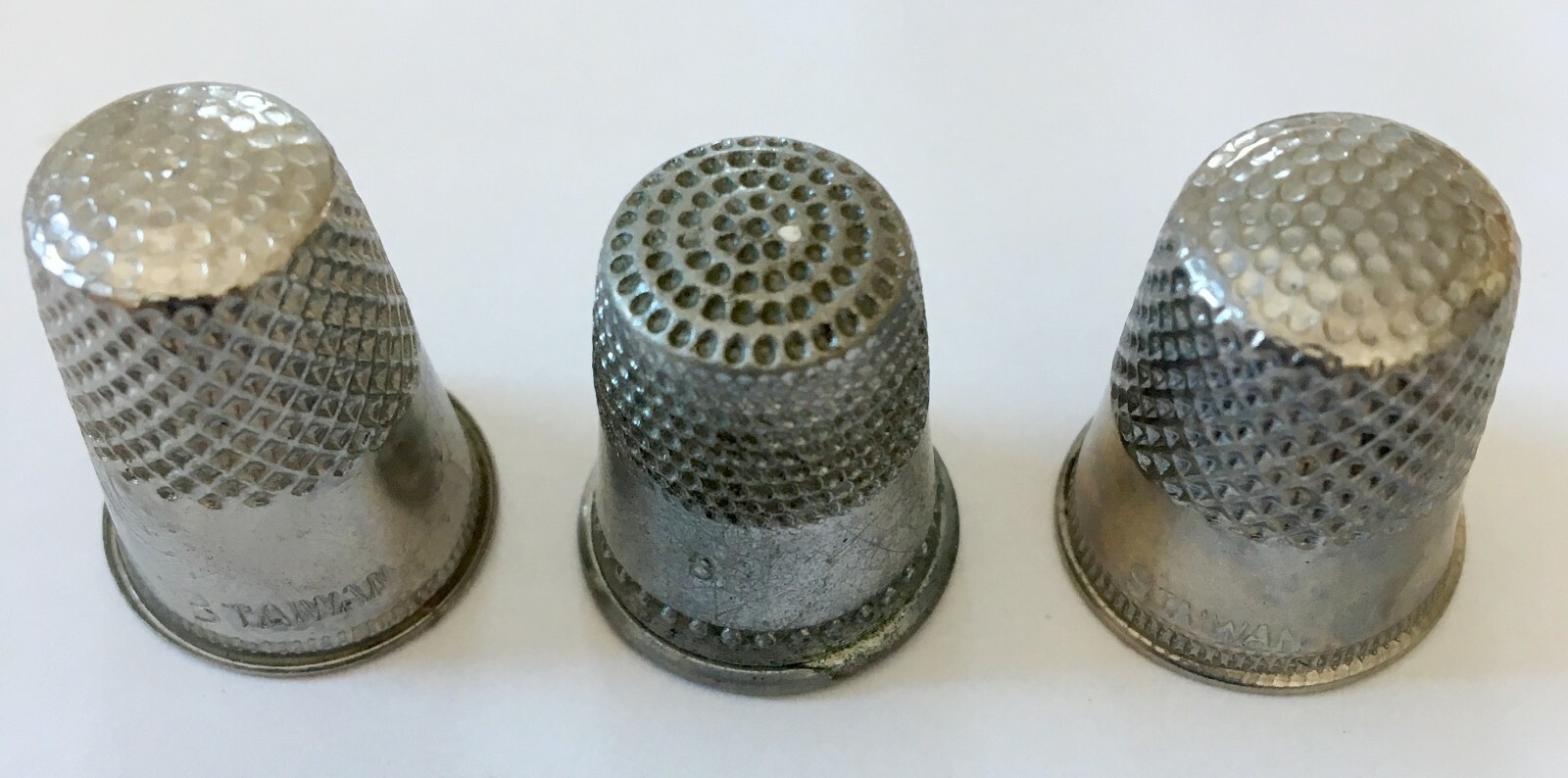 LOT OF NINE METAL AND PLASTIC THIMBLES