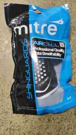 Shin guards by Mitre and ball pump