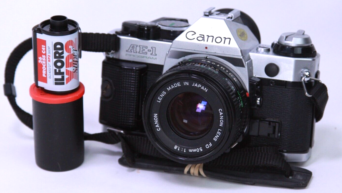 Canon AE-1 Program Camera w/ FD 50mm F/1.8 Lens Sporty Grip Canon AE-1 Program Camera w/ FD 50mm F/1.8 Lens Sporty Grip