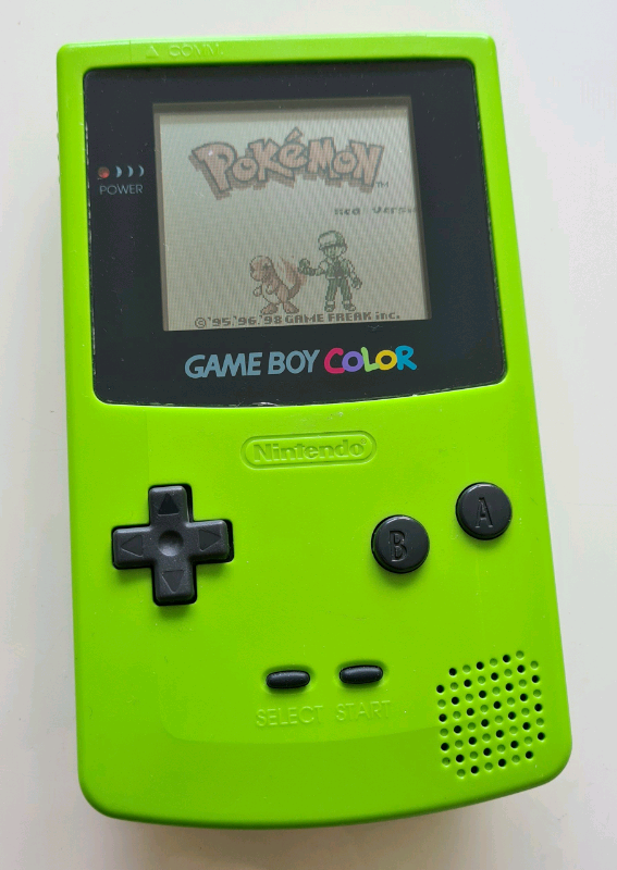 Gameboy color lime green with pokemon red and power supply. in