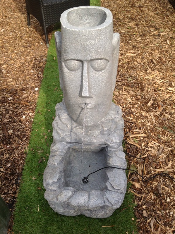 Solar powered Easter Island Head water feature with LEDs in Earley