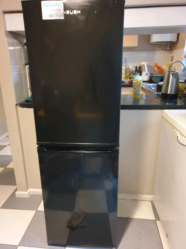 A slim black fridge freezer nearly new perfect working condition in