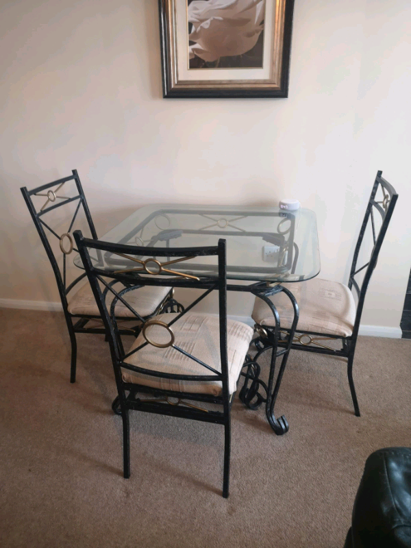 Wrought Iron Glass dining table with 4 chairs and matching glass toppe