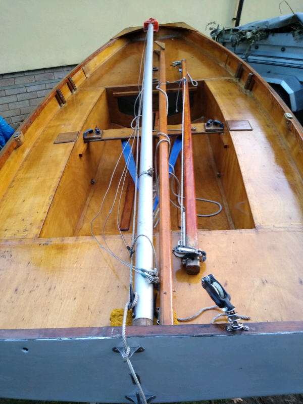 Mirror sailing dinghy boat with launching trolley ready to sail away