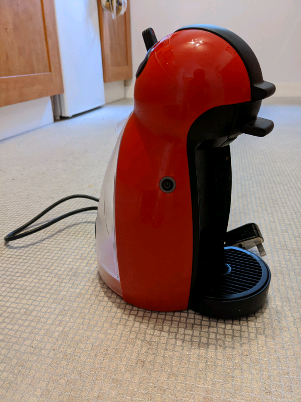 Manual Dolce Gusto coffee machine with assorted coffee pods in