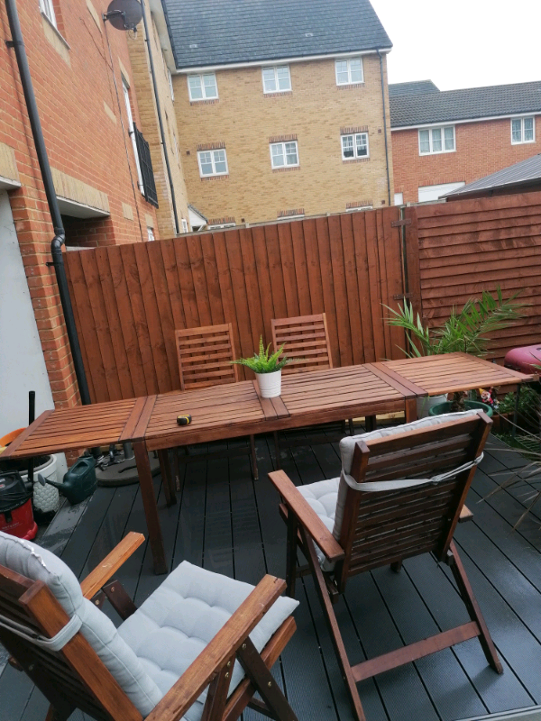 IKEA wooden garden table with 4 chairs and 2 cushions. in Purfleet