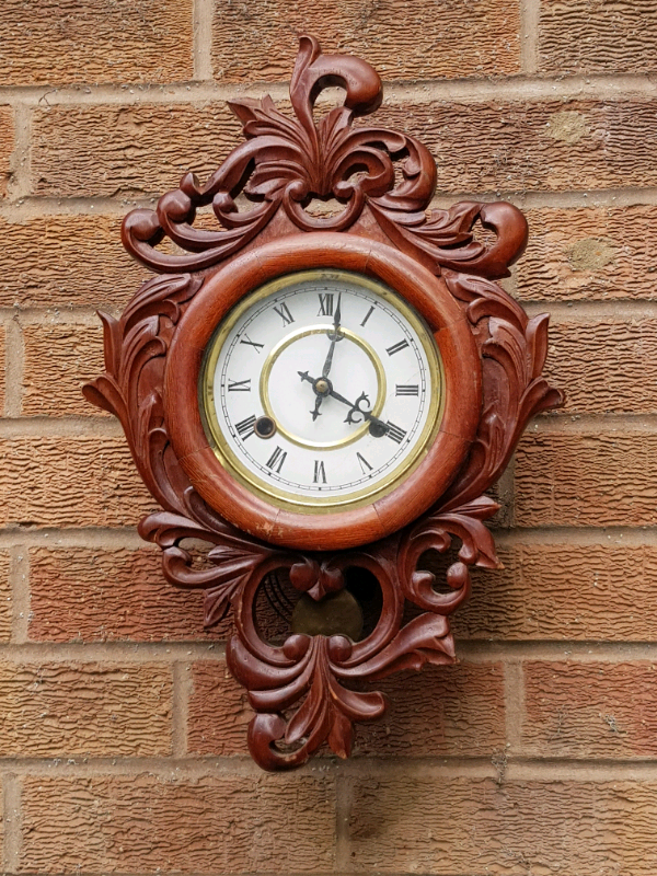 Vintage carved wood chiming wall clock in Enderby, Leicestershire