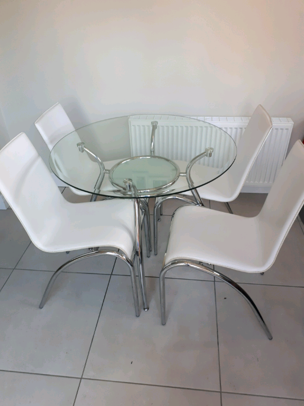 Round glass table with 4 white chairs for sale. 900mm d x 760mm h. in Antrim, County Antrim