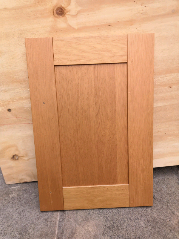 Oak effect kitchen wall and solid oak cupboard door. in