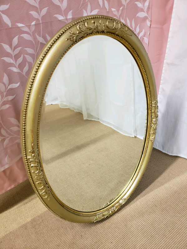 Vintage heavy large oval mirror with gold ornate mirror bevelled edge