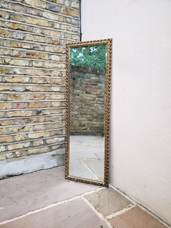 Vintage tall narrow mirror with gold ornate frame, bevelled in