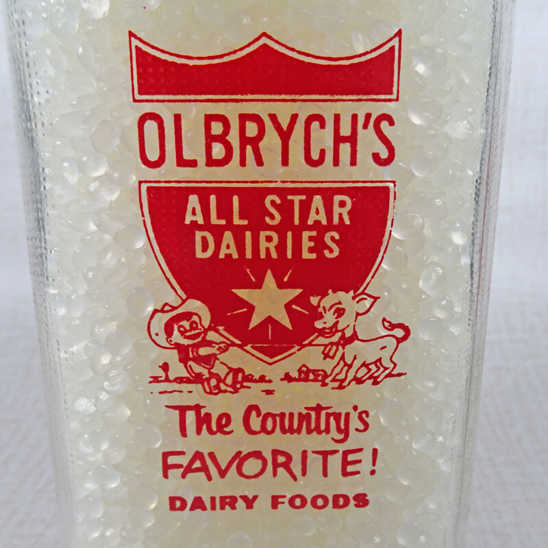 Olbrych's Dairy Vintage ACL Glass Quart Milk Bottle. Red Graphics. Textured Body