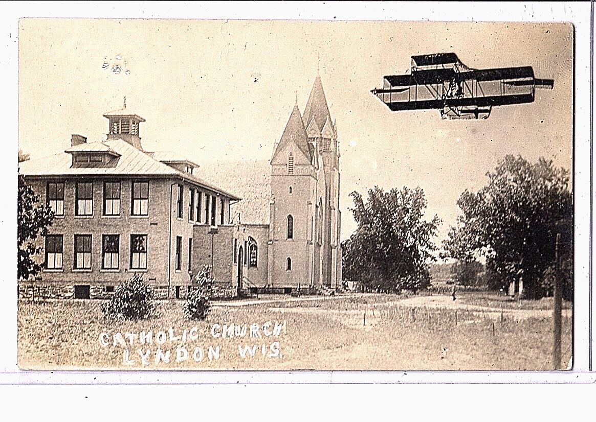 Surreal RPPC - Exaggeration Airplane near Catholic Church Lyndon Wisconsin