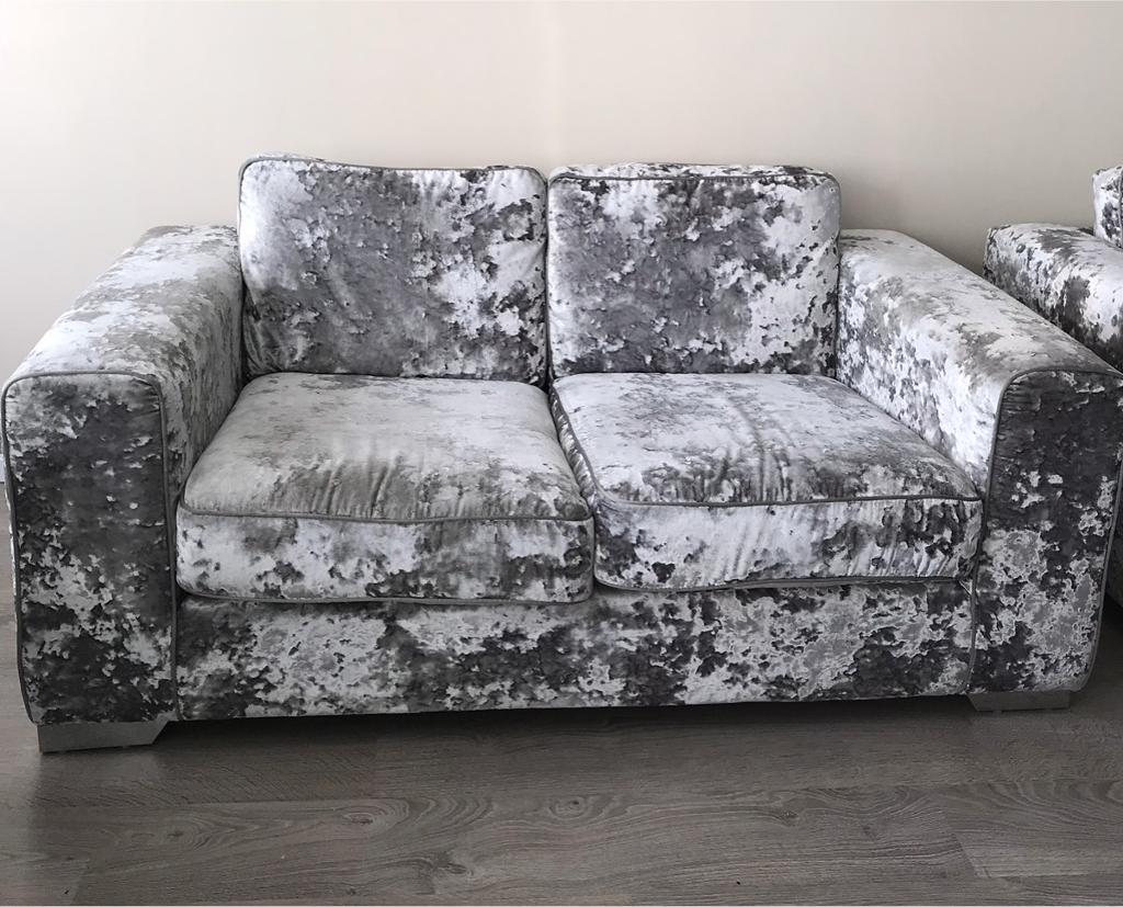 Very expensive crushed silver velvet two seat sofa in Whitley Bay