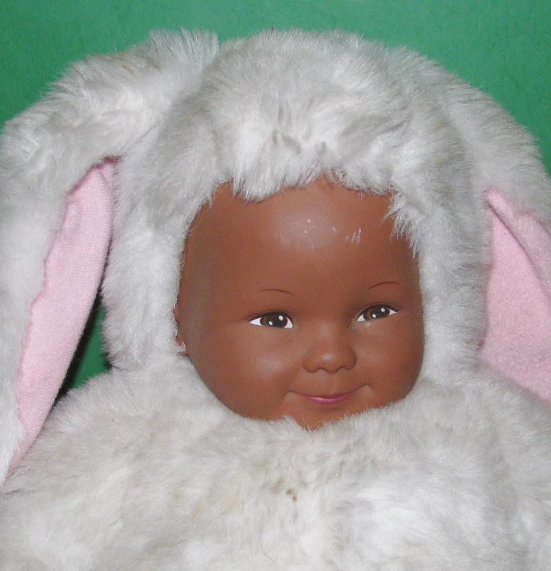 Brown Skinned Geddes Baby with White Bunny Outfit/Good Condition & cute.
