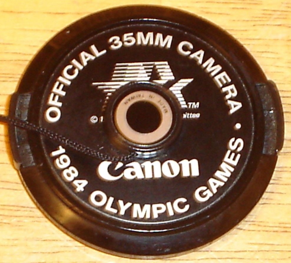 Canon Official 35mm Camera 1984 Olympic Games 52mm Lens Cap w/ Strap - Near-Mint