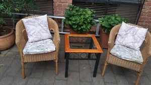 3 piece indoor outdoor setting 2 cane chairs and 1 table and 4 cush