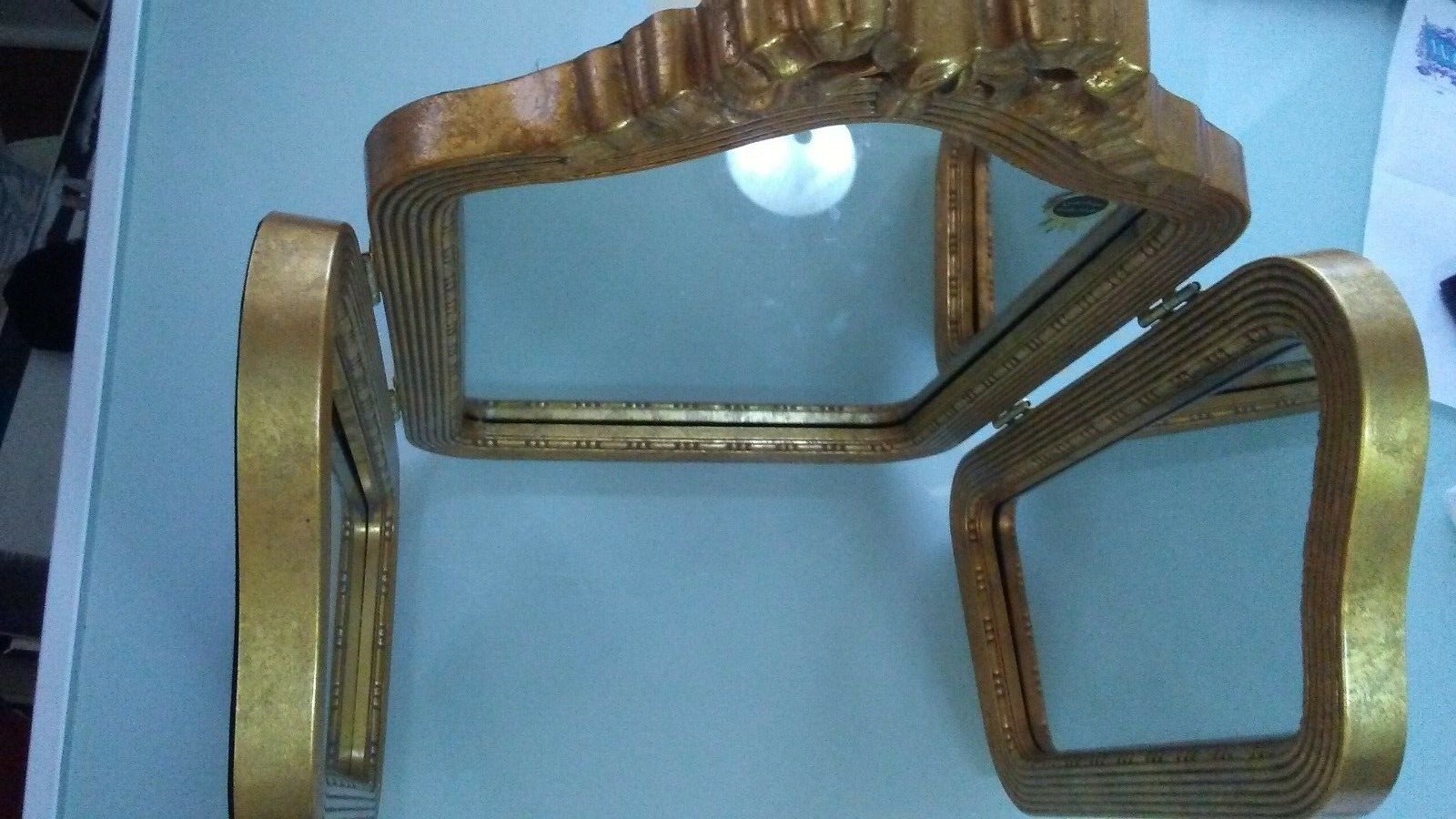 Antique three panel mirror in ornate goldtone frame