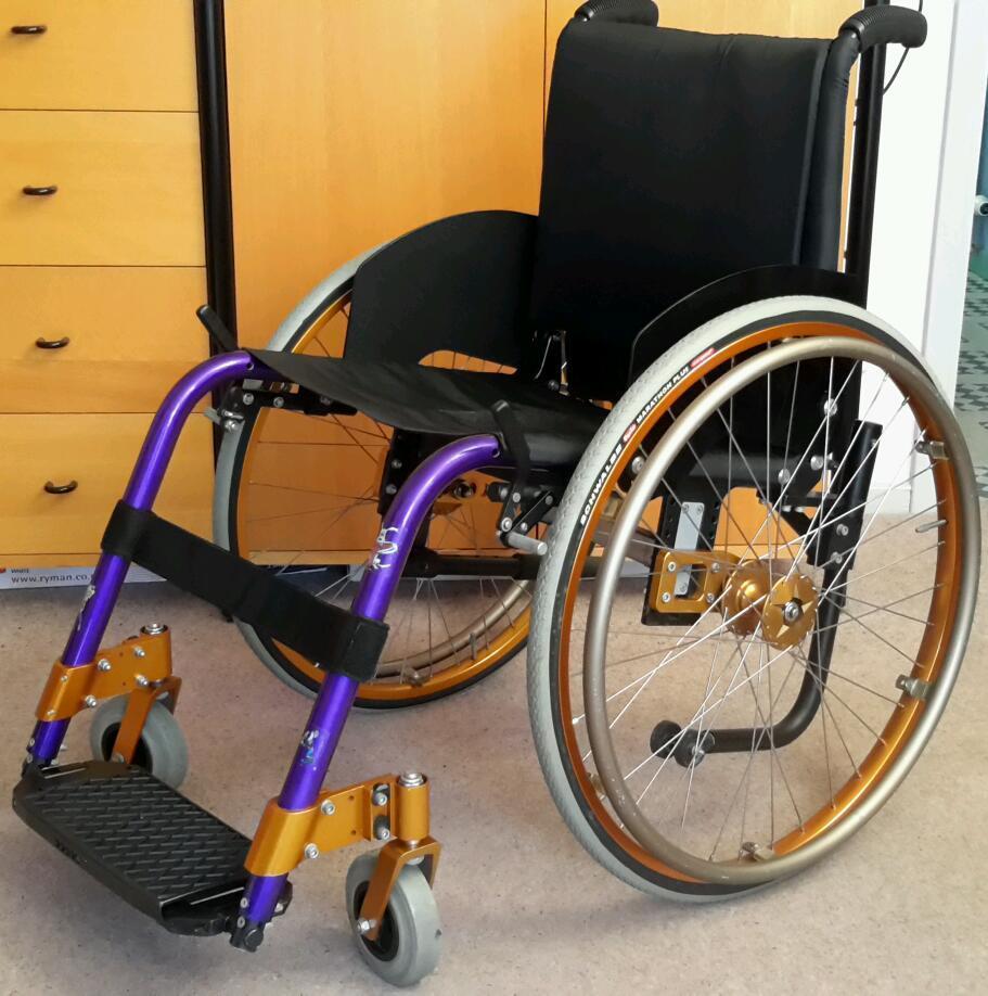 KÜSCHALL CHAMPION NEO lightweight folding wheelchair stored indoors