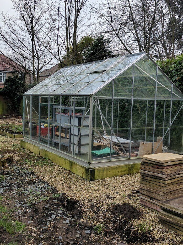 as new about a year old 12x8 greenhouse with base 