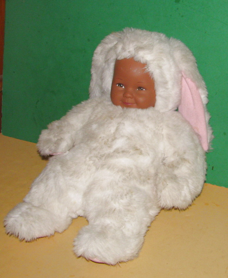 Brown Skinned Geddes Baby with White Bunny Outfit/Good Condition & cute.