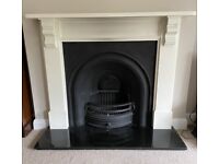 Cast iron fireplace with granite hearth and wood mantelpiece