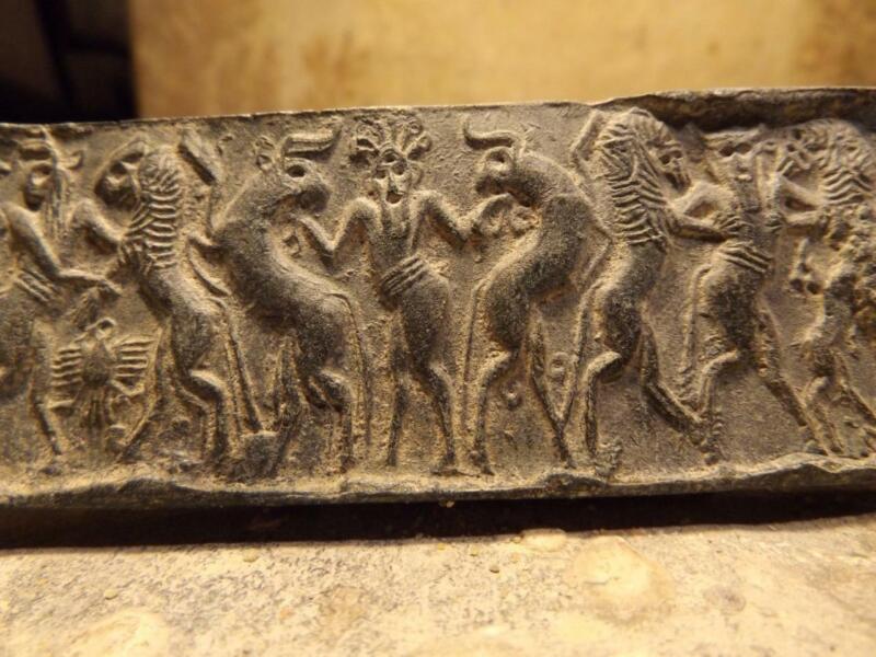 Sumerian cylinder seal impression - Master of animals. Museum replica.