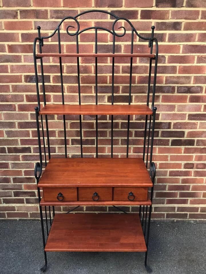 Modern wrought iron wall unit with wooden shelves and drawers in West