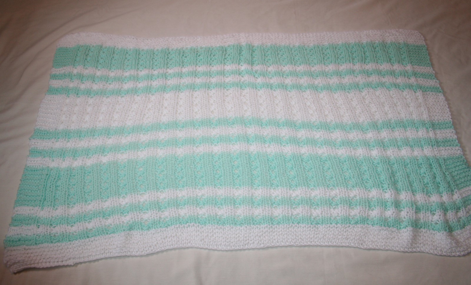 HAND KNITTED WHITE & GREEN BABY BLANKET