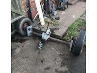 Braked axle trailer and hitch coupling