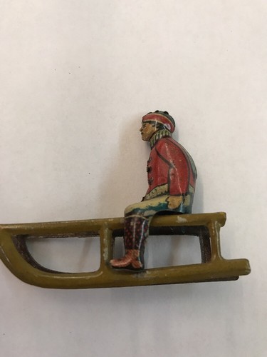 1930s GERMAN TIN PENNY TOY BOY ON SLED ANTIQUE TOY
