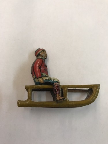 1930s GERMAN TIN PENNY TOY BOY ON SLED ANTIQUE TOY