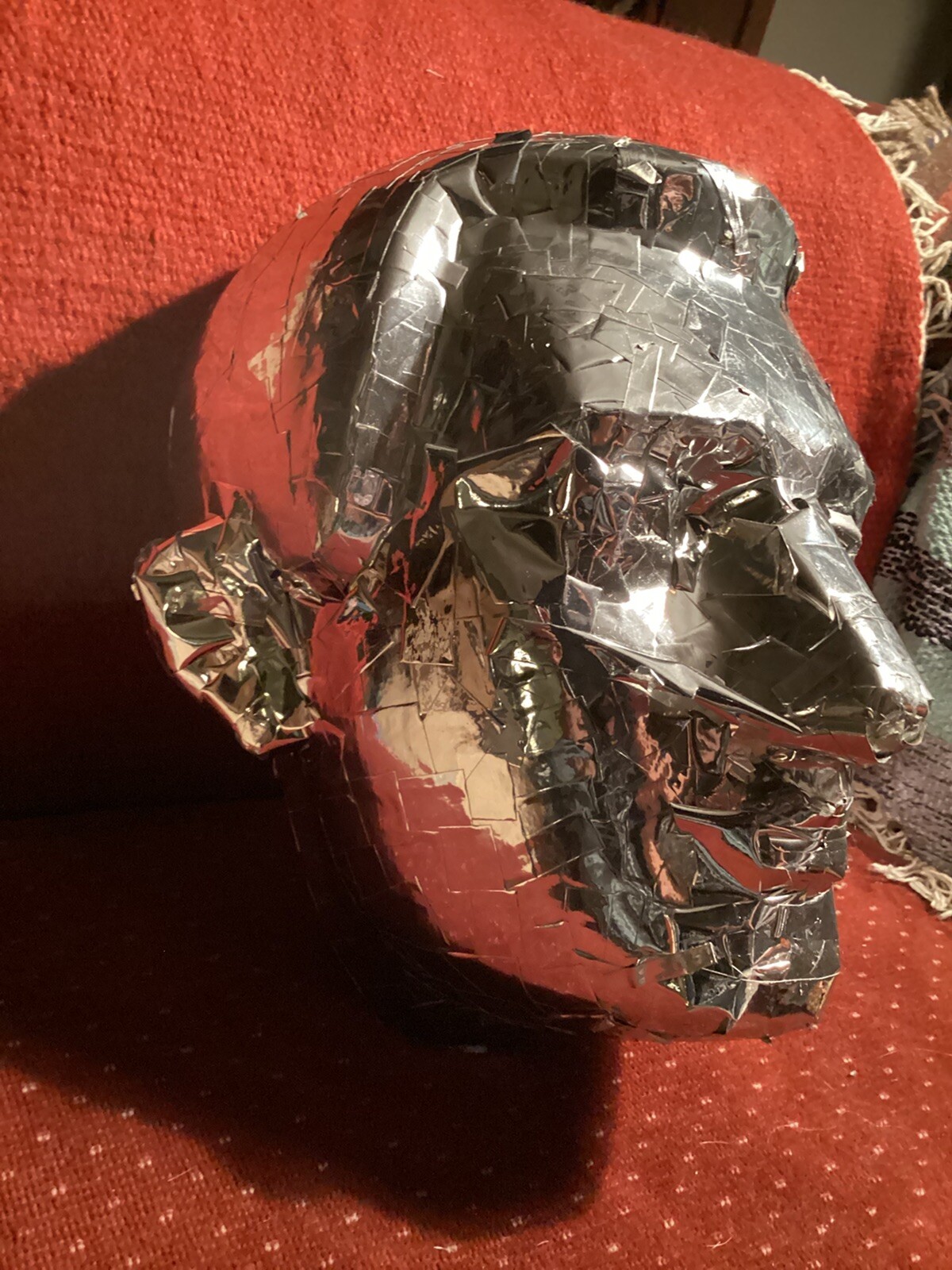 tinfoil covered man’s face mask, lifesized at 12” high x 10” wide x 10