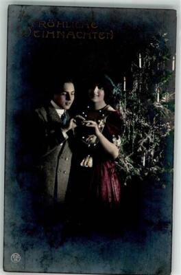 39681480 - Young man puts a ring on his wife in front of the Christmas tree