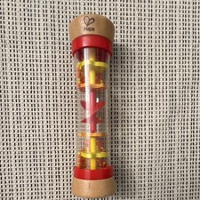 Hape Baby Rattle Shaker tube transparent avec perles colorées, pièces tournantes, extrémités rouges