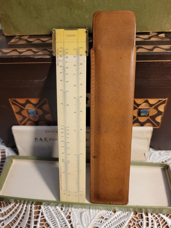 A Keuffel & Esser pocket slide rule in its original leather sleeve AND original box — K&E is the Rolls-Royce of slide rules, and the complete packaging makes this a perfect gift.