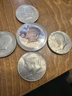 5 Kennedy Half Dollars. One Colorized