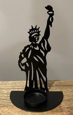 Black metal Statue of Liberty-shaped, light candle holder.