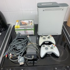 Xbox 360, 60GB plus 2 controllers power block and cables 8 Games Untested.