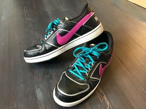 black nike shoes with teal swoosh