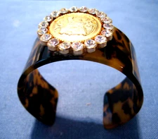 Faux Tortoise shell cuff w gold coin and rhinestone embellishment. Classic