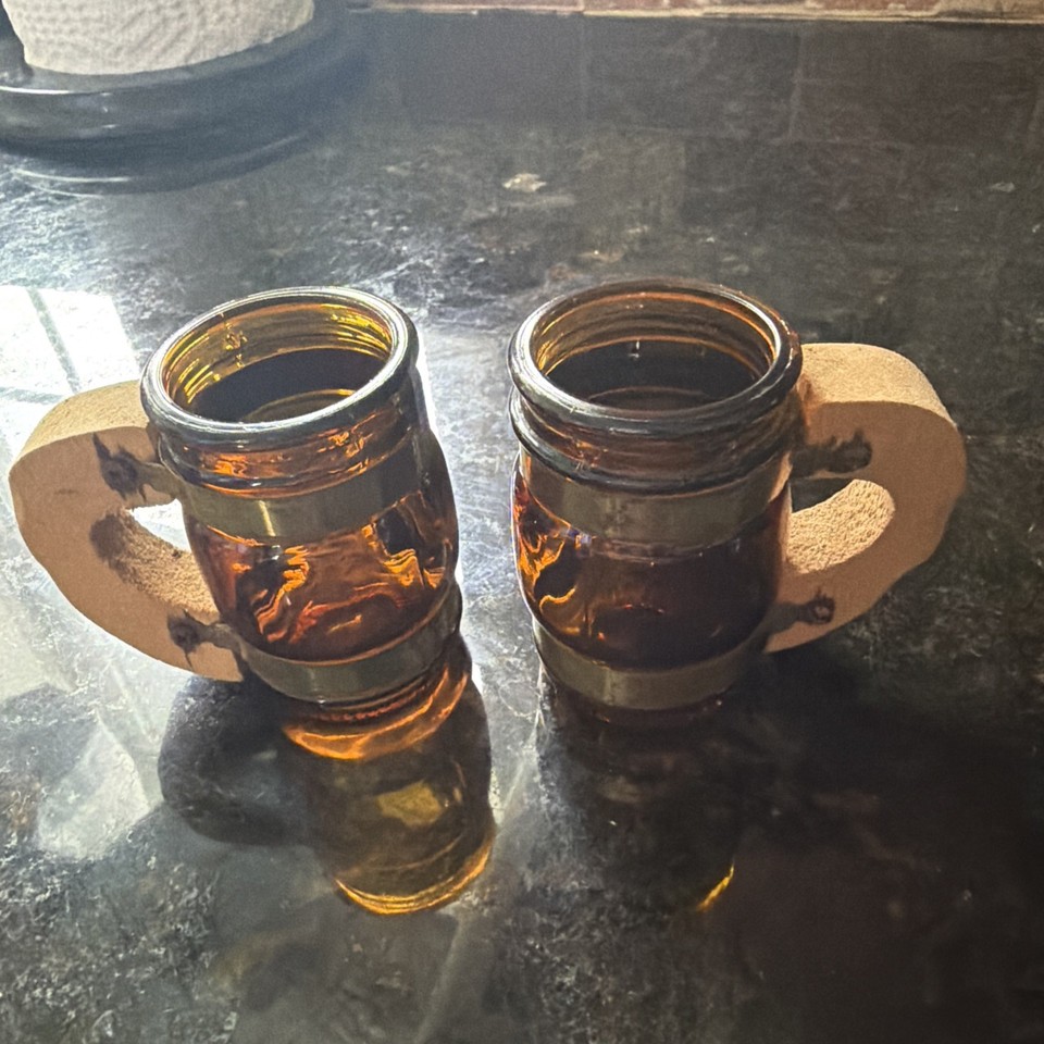 A 1960s Siestaware shot glass with a wooden handle — the tiki-era novelty that looks like a tiny mug and feels wildly specific in the best way.