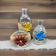 3 Glass Bottles For Decor Wrapped With Jute With Colorful Metal Flower