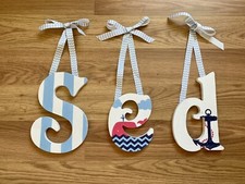 Preowned set of three wooden letters S E D hangs on wall used