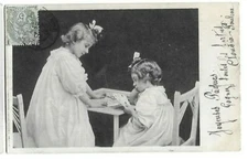 Old postcard portrait of two girls playing cards