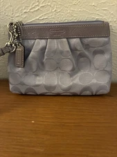 Coach Corner Zip Wristlet in a lilac color, featuring the brand's signature Logo