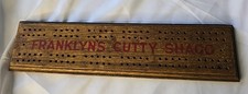 Vintage wooden cribbage board features branding for FRANKLYN'S CUTTY SHAGG