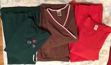 Three sets of nursing scrubs: top and pants green, brown red. XS and small